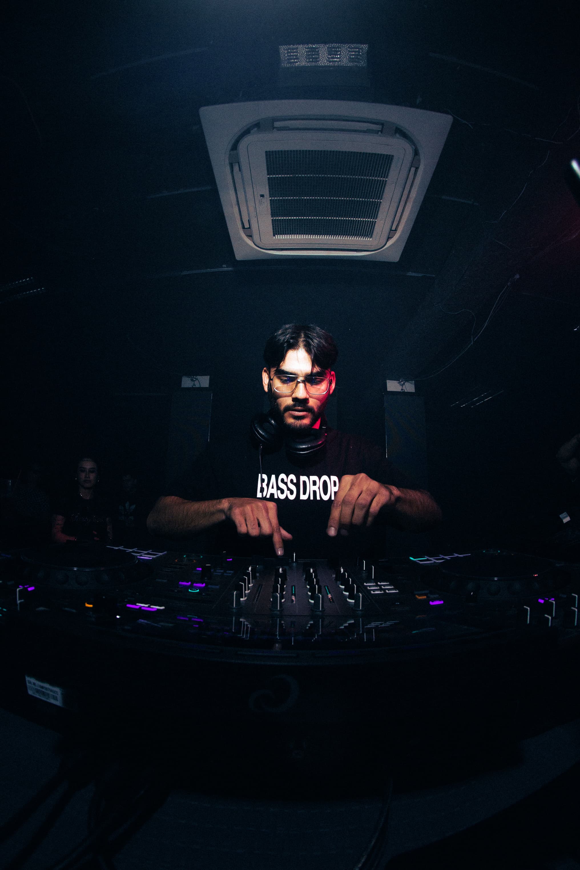 Roger Rave focused at the DJ booth during a live set.